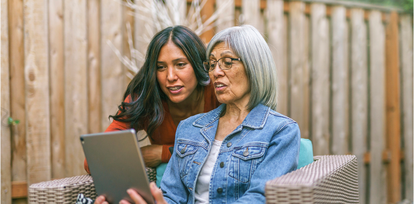 mom and daughter looking at computer together