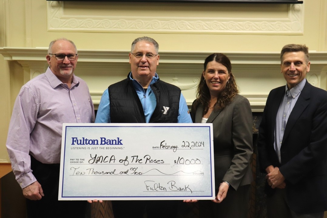 Members of the YMCA of the Roses receive a donation check from Cavity Bank